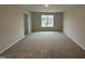 Neutral bedroom with plush carpet, a large window with a view, and freshly painted walls at 9 W Emily Gardens Dr, Selma, NC 27576