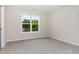 This room features a large window, neutral paint, and plush carpet at 9 W Emily Gardens Dr, Selma, NC 27576