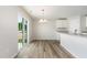 Bright dining area with wood floors, a sliding glass door, and a modern chandelier at 9 W Emily Gardens Dr, Selma, NC 27576