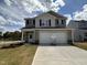 Charming two-story home featuring a two-car garage, neutral siding, and a well-manicured lawn and driveway at 9 W Emily Gardens Dr, Selma, NC 27576