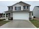 Two-story home with a two-car garage, neutral siding, and a well-maintained lawn on a cloudy day at 9 W Emily Gardens Dr, Selma, NC 27576