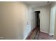 Hallway leading to a half bathroom with white fixtures and modern design elements at 9 W Emily Gardens Dr, Selma, NC 27576