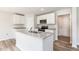Modern kitchen featuring a central island with granite countertops, stainless appliances, and stylish cabinets at 9 W Emily Gardens Dr, Selma, NC 27576