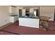 Bright kitchen with white cabinets, stainless appliances, and a granite countertop island ready for finishing touches at 9 W Emily Gardens Dr, Selma, NC 27576