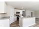 Bright kitchen features white cabinets, granite countertops, stainless appliances, and wood-look flooring at 9 W Emily Gardens Dr, Selma, NC 27576
