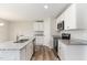 Open kitchen with an island, stainless appliances, white cabinets and attractive countertops at 9 W Emily Gardens Dr, Selma, NC 27576