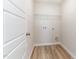 Practical laundry room offers hookups, a wire shelf, and wood-look flooring at 9 W Emily Gardens Dr, Selma, NC 27576