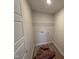 A dedicated laundry room with hookups, a storage shelf, and room for organizing laundry essentials at 9 W Emily Gardens Dr, Selma, NC 27576