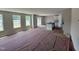 Bright and spacious living room featuring multiple windows, open space, and an adjacent kitchen area at 9 W Emily Gardens Dr, Selma, NC 27576