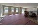 Spacious living room featuring large windows for abundant natural light and a partial view of the kitchen at 9 W Emily Gardens Dr, Selma, NC 27576