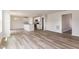 Bright living space showcases an open kitchen with white cabinets and seamless flow with wood floors at 9 W Emily Gardens Dr, Selma, NC 27576