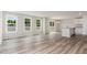 Open-concept living space features wood floors, a kitchen island, and a sliding glass door at 9 W Emily Gardens Dr, Selma, NC 27576