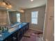 Modern bathroom with double sinks, a large mirror, and ample counter space on a navy blue vanity at 9 W Emily Gardens Dr, Selma, NC 27576