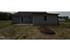 Exterior shot of the back of the home with siding, a patio, and an unfinished lawn at 91 Harvest Hills Ln, Dunn, NC 28334