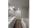 Bathroom featuring a double sink vanity, wood flooring, and a separate tub and toilet space at 91 Harvest Hills Ln, Dunn, NC 28334