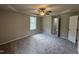 A spacious carpeted bedroom with a large window and neutral walls features an adjoining bathroom at 91 Harvest Hills Ln, Dunn, NC 28334