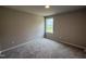 Cozy bedroom with neutral walls, plush carpeting, and a bright window at 91 Harvest Hills Ln, Dunn, NC 28334