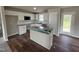 Well-equipped kitchen with white cabinets, modern appliances, and a granite countertop island at 91 Harvest Hills Ln, Dunn, NC 28334