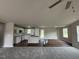 Open-concept kitchen with white cabinets, stainless steel appliances, and an island at 91 Harvest Hills Ln, Dunn, NC 28334