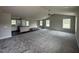 Open-concept living space featuring neutral walls, plush carpeting, and modern lighting at 91 Harvest Hills Ln, Dunn, NC 28334