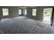 A spacious living room with new carpet, large windows, and ample natural light at 91 Harvest Hills Ln, Dunn, NC 28334