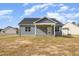 Rear view of home with covered back patio and backyard at 98 Laramie Ln, Selma, NC 27576