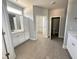 Bathroom with a walk-in closet, white cabinets, and tile flooring at 98 Laramie Ln, Selma, NC 27576