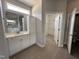 Bathroom with white cabinets, tile flooring, and view into walk-in closet at 98 Laramie Ln, Selma, NC 27576