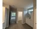 Bathroom featuring ceramic tile floor, grey walls, double sink with white cabinetry, and walk in closet at 98 Laramie Ln, Selma, NC 27576