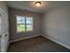 Neutral bedroom with standard double door closet, plush carpet, and a window with a beautiful lawn view at 98 Laramie Ln, Selma, NC 27576