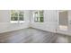 Bright dining area featuring white trim, white walls, and gray wood-look flooring at 98 Laramie Ln, Selma, NC 27576