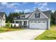 Well-manicured one-story home showcasing a two-car garage and an inviting front yard at 98 Laramie Ln, Selma, NC 27576
