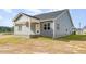 Back exterior of home with covered back patio and back door at 98 Laramie Ln, Selma, NC 27576