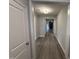 Inviting hallway with elegant wood flooring and neutral paint, leading to a living area at 98 Laramie Ln, Selma, NC 27576