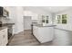 Contemporary kitchen featuring white cabinets, granite counters, and stainless appliances at 98 Laramie Ln, Selma, NC 27576