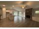 Open concept living room with stone fireplace, and open to the kitchen and dining area at 98 Laramie Ln, Selma, NC 27576