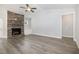 Open living room featuring a stone fireplace, neutral walls, and wood-look floors at 98 Laramie Ln, Selma, NC 27576