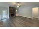 Spacious living room featuring a stone fireplace, ceiling fan, and wood-look floors at 98 Laramie Ln, Selma, NC 27576