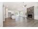 Bright living room with stone fireplace, granite counters, and expansive wood-look floors at 98 Laramie Ln, Selma, NC 27576