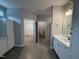 Main bathroom with dual vanities, tile floors, and open access to the walk-in closet at 98 Laramie Ln, Selma, NC 27576