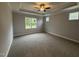 Spacious main bedroom with a tray ceiling, ceiling fan, and carpeted flooring at 98 Laramie Ln, Selma, NC 27576