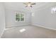 The main bedroom features plush carpet flooring, a window, and neutral paint at 98 Laramie Ln, Selma, NC 27576