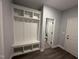 Mudroom features bench seating with storage and access to a half bathroom at 98 Laramie Ln, Selma, NC 27576