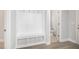 The mudroom has white millwork, tile flooring and a coat rack with bench at 98 Laramie Ln, Selma, NC 27576