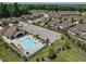Aerial view of a community pool with a clubhouse and parking area at 1005 Vesper Ct, Durham, NC 27703