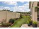 Cozy backyard featuring a decorative flower garden and green synthetic grass at 1005 Vesper Ct, Durham, NC 27703