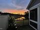 Backyard view of a tranquil pond during a colorful sunset at 1005 Vesper Ct, Durham, NC 27703