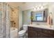 Well-lit bathroom with a shower-tub, and granite vanity at 1005 Vesper Ct, Durham, NC 27703