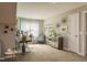 This bonus room has a seating area that features a teal accent wall, a large window, and unique decor at 1005 Vesper Ct, Durham, NC 27703