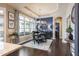Light-filled dining room with modern chandelier, blue accent wall, and access to outdoor patio at 1005 Vesper Ct, Durham, NC 27703